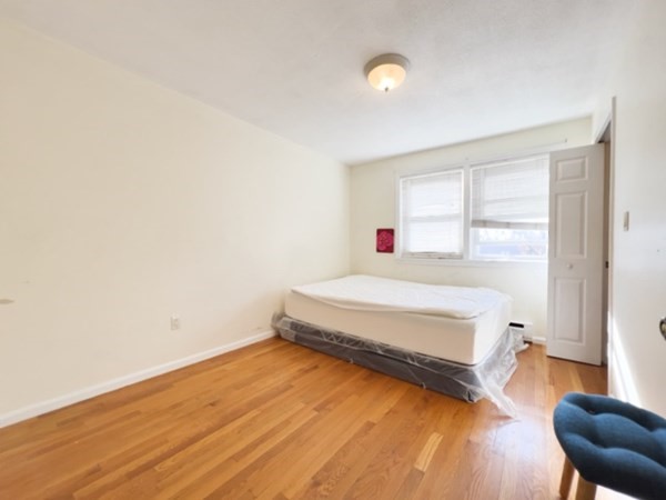 45 Lawn Street, Unit PE Boston, MA 02120 - Photo 15 of 26 a spacious bedroom with a bed and a window
