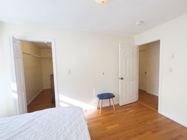 45 Lawn Street, Unit PE Boston, MA 02120 - Photo 19 of 26 a bedroom with a bed and a table