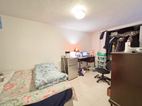 45 Lawn Street, Unit PE Boston, MA 02120 - Photo 20 of 26 a bedroom with a bed and cabinets