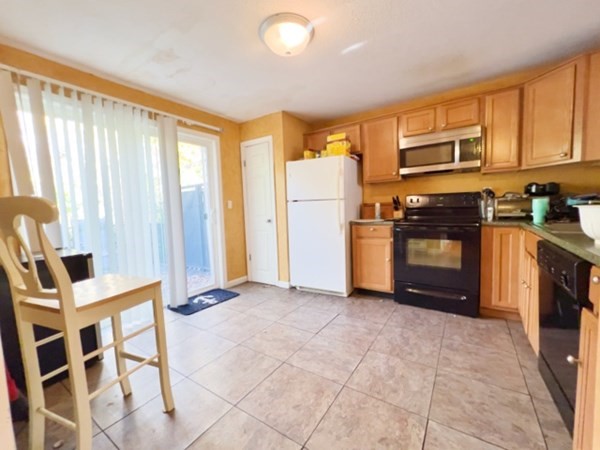 45 Lawn Street, Unit PE Boston, MA 02120 - Photo 2 of 26 a kitchen with stainless steel appliances granite countertop a refrigerator and a stove top oven