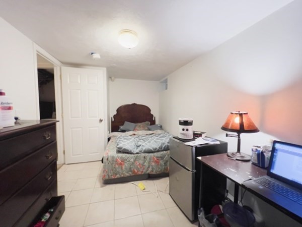 45 Lawn Street, Unit PE Boston, MA 02120 - Photo 25 of 26 a bedroom with a bed and a desk