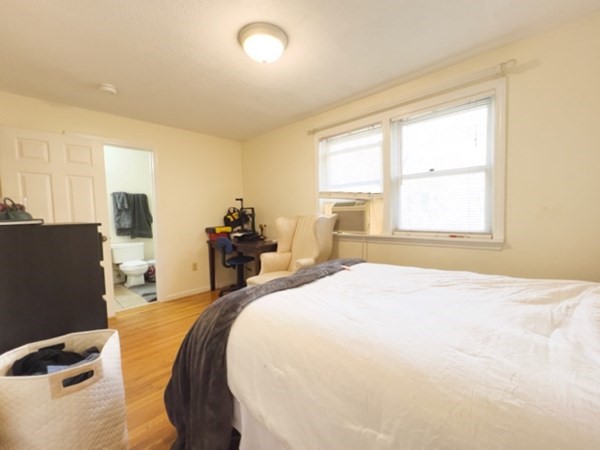 45 Lawn Street, Unit PE Boston, MA 02120 - Photo 9 of 26 a bed sitting in a spacious bedroom next to a window