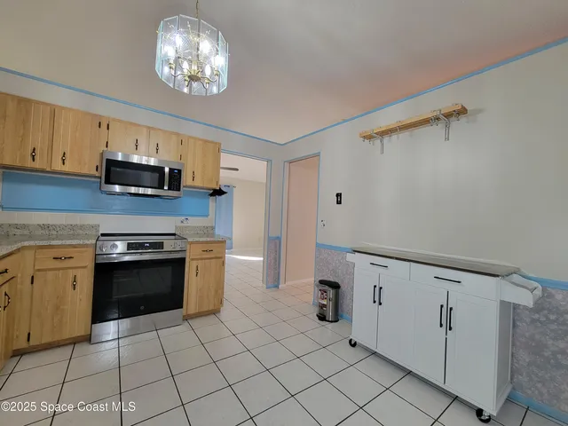 a kitchen with granite countertop cabinets and stainless steel appliances