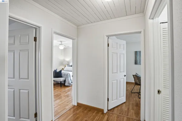 a view of a hallway and closet and wooden floor