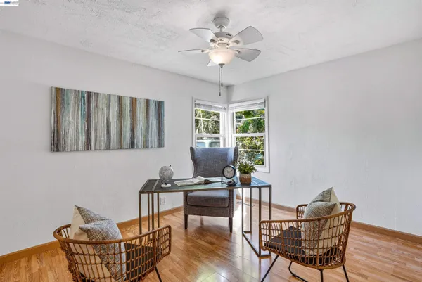 a view of a dining room with furniture and a potted plant