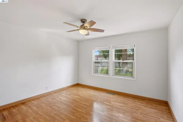 a view of a house with a deck and furniture