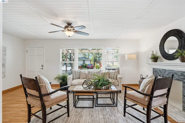a living room with furniture a chandelier and a window