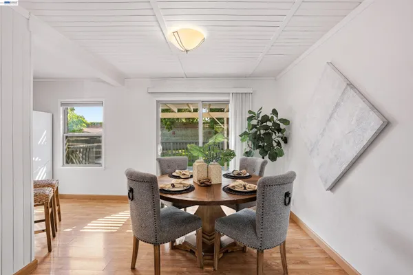 a view of a dining room with furniture window and wooden floor