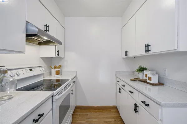 a kitchen with stainless steel appliances a sink a stove and cabinets