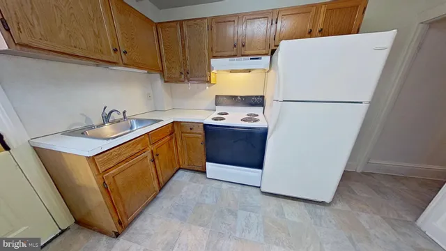 a kitchen with stainless steel appliances a refrigerator sink and cabinets