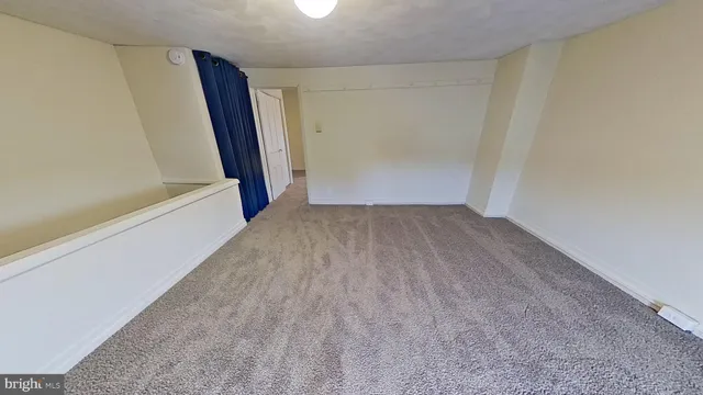 a view of an empty room with stairs