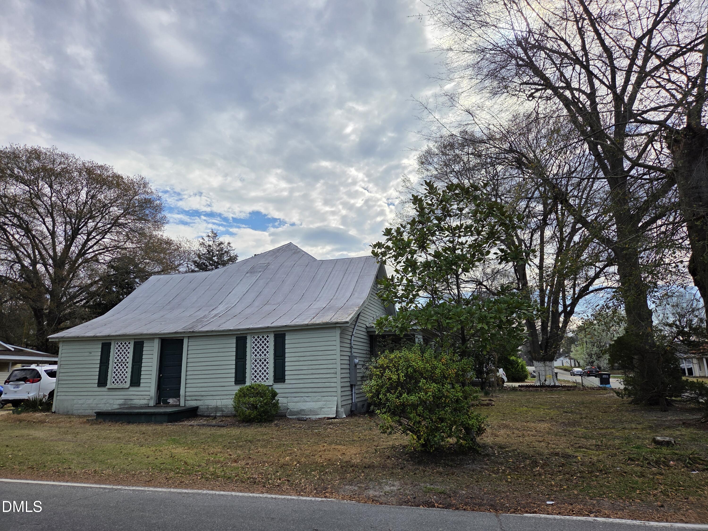 812 West Anderson Street Selma, NC 27576 - Photo 19 of 20 a front view of a house with a garden