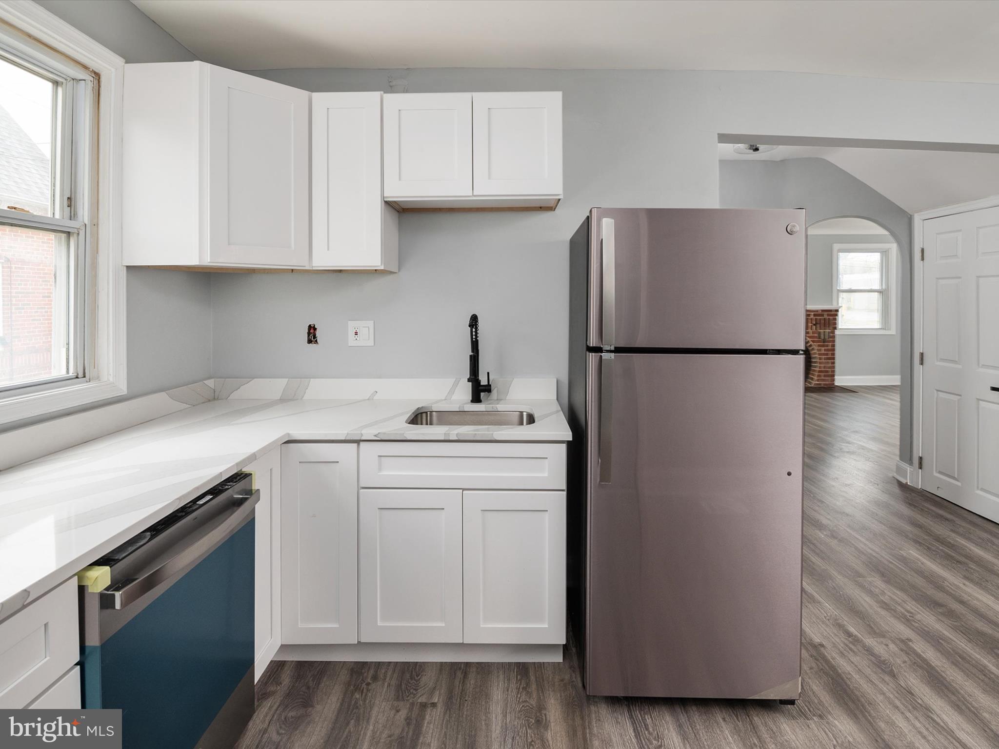 5002 Silver Hill Road Suitland, MD 20746 - Photo 11 of 39 a kitchen with a sink a refrigerator and cabinets