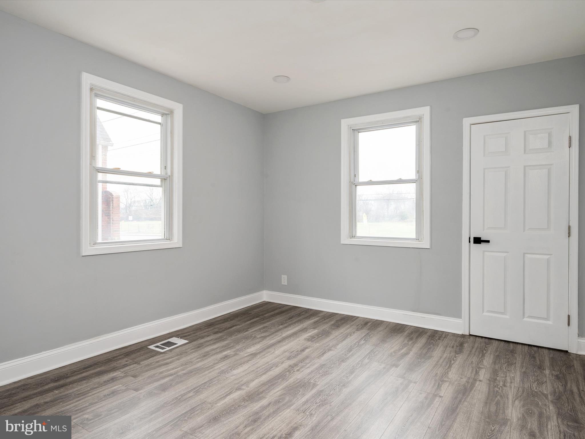 5002 Silver Hill Road Suitland, MD 20746 - Photo 14 of 39 a view of a room with wooden floor and windows in it
