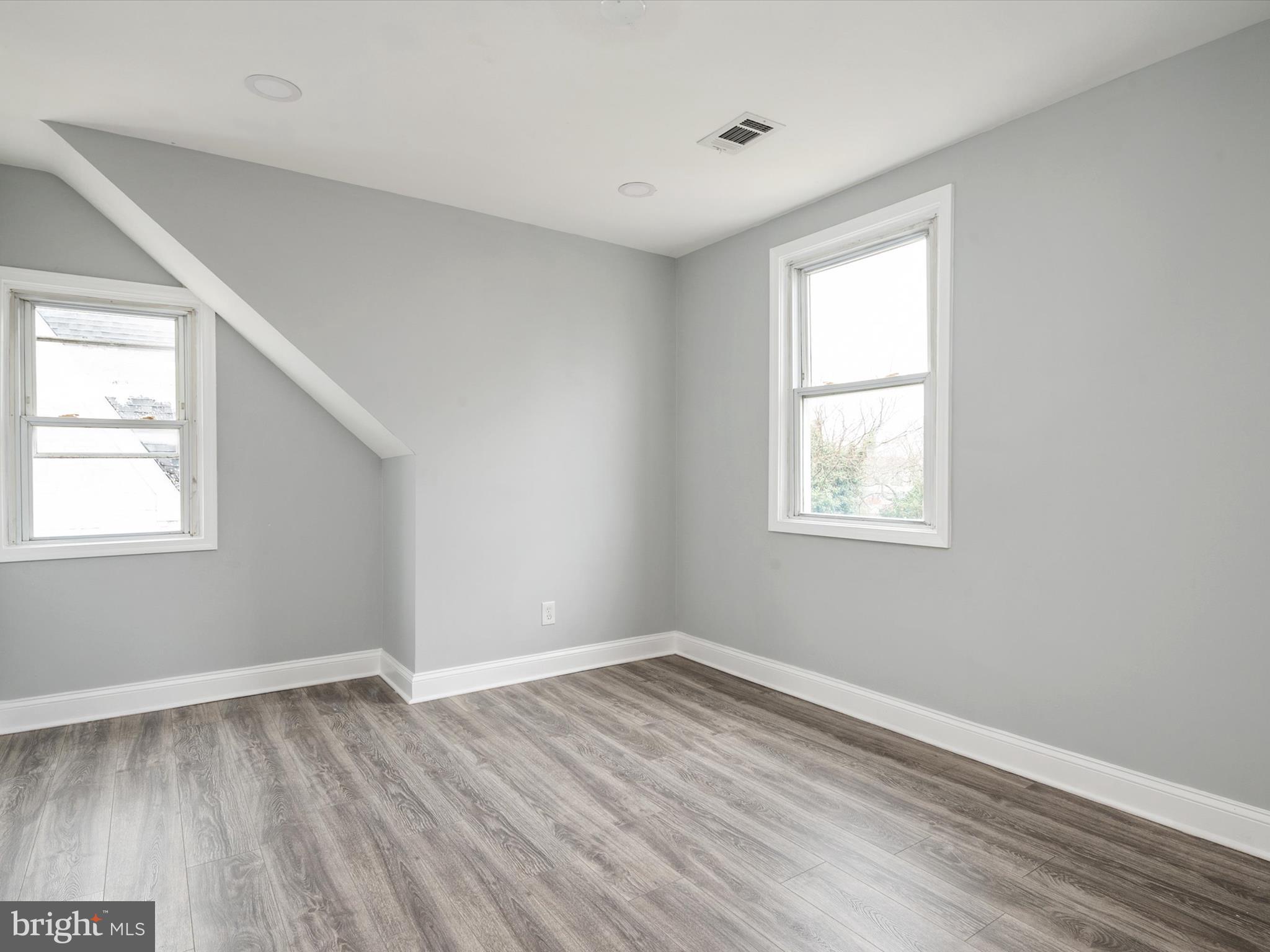 5002 Silver Hill Road Suitland, MD 20746 - Photo 17 of 39 an empty room with wooden floor and windows