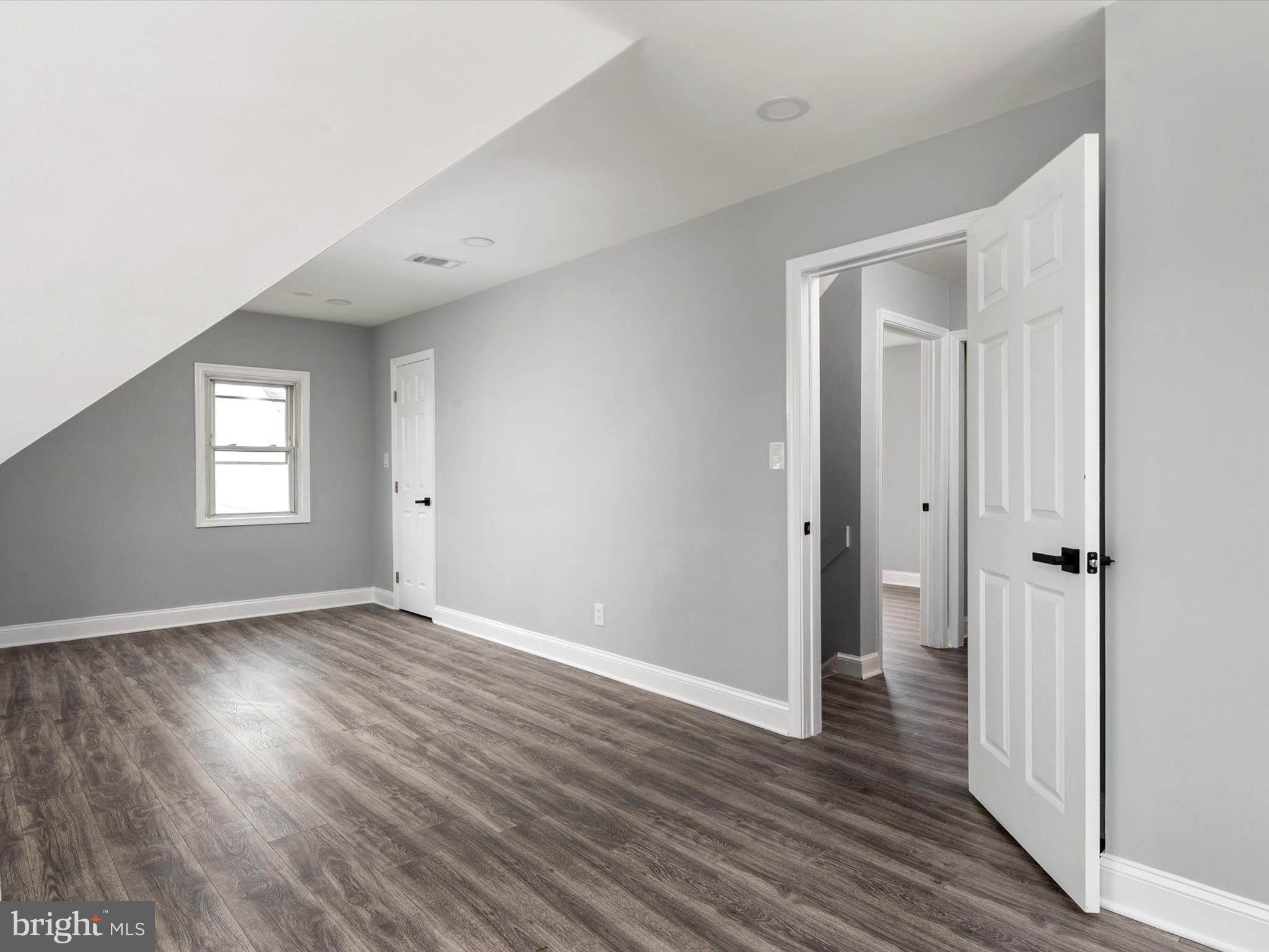 5002 Silver Hill Road Suitland, MD 20746 - Photo 19 of 39 a view of an empty room with wooden floor and a window