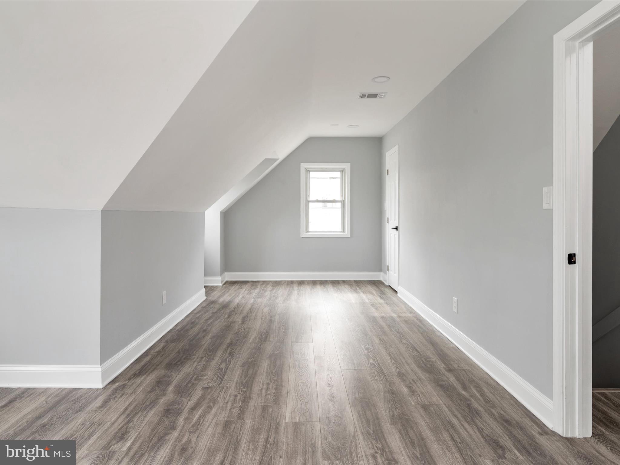 5002 Silver Hill Road Suitland, MD 20746 - Photo 21 of 39 a view of an empty room with wooden floor and window
