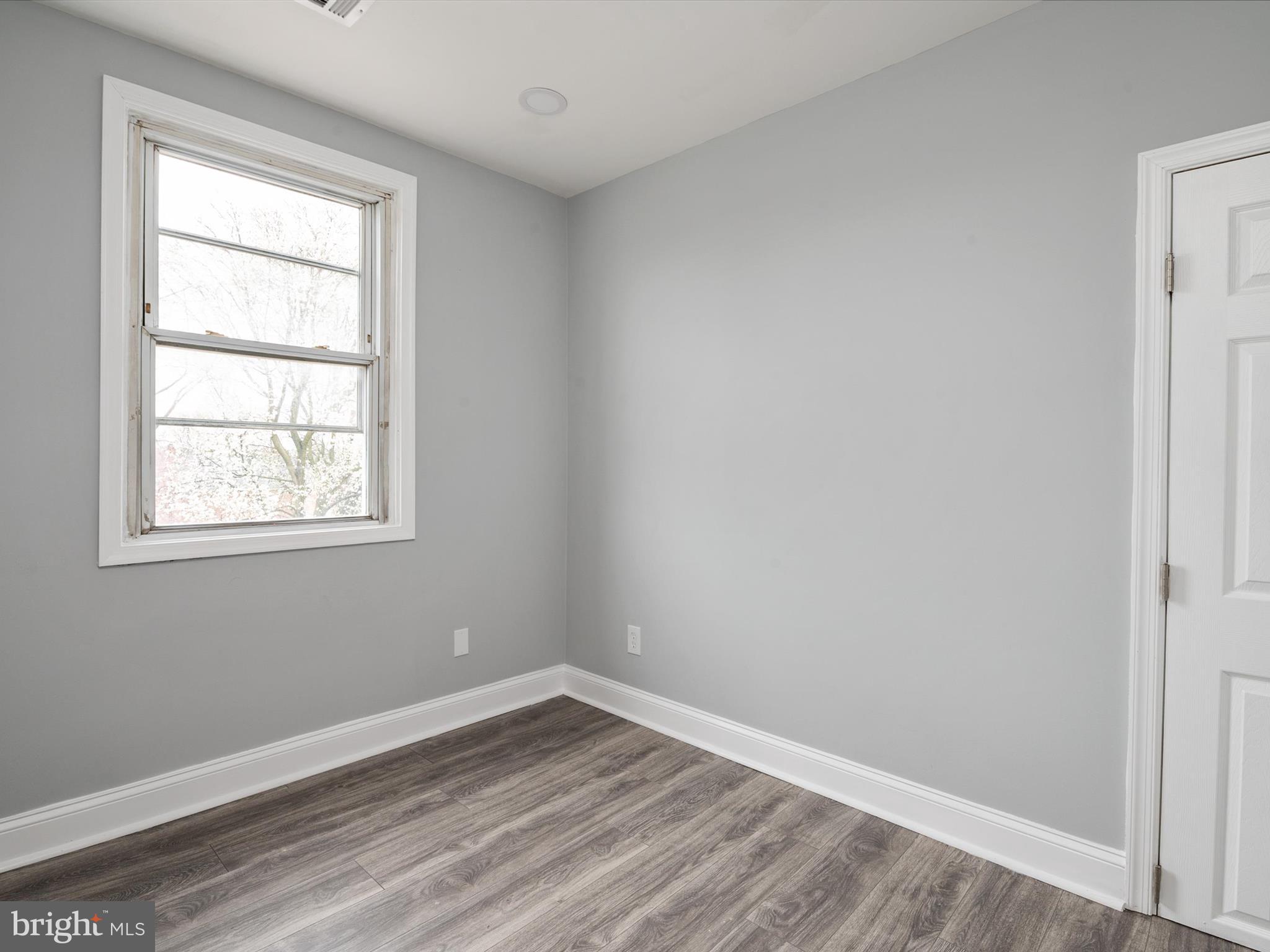 5002 Silver Hill Road Suitland, MD 20746 - Photo 22 of 39 an empty room with wooden floor and windows