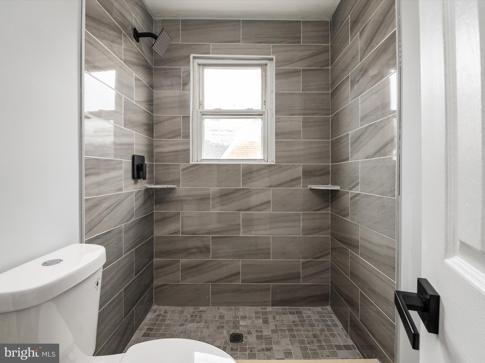 5002 Silver Hill Road Suitland, MD 20746 - Photo 24 of 39 a bathroom with a toilet and a shower