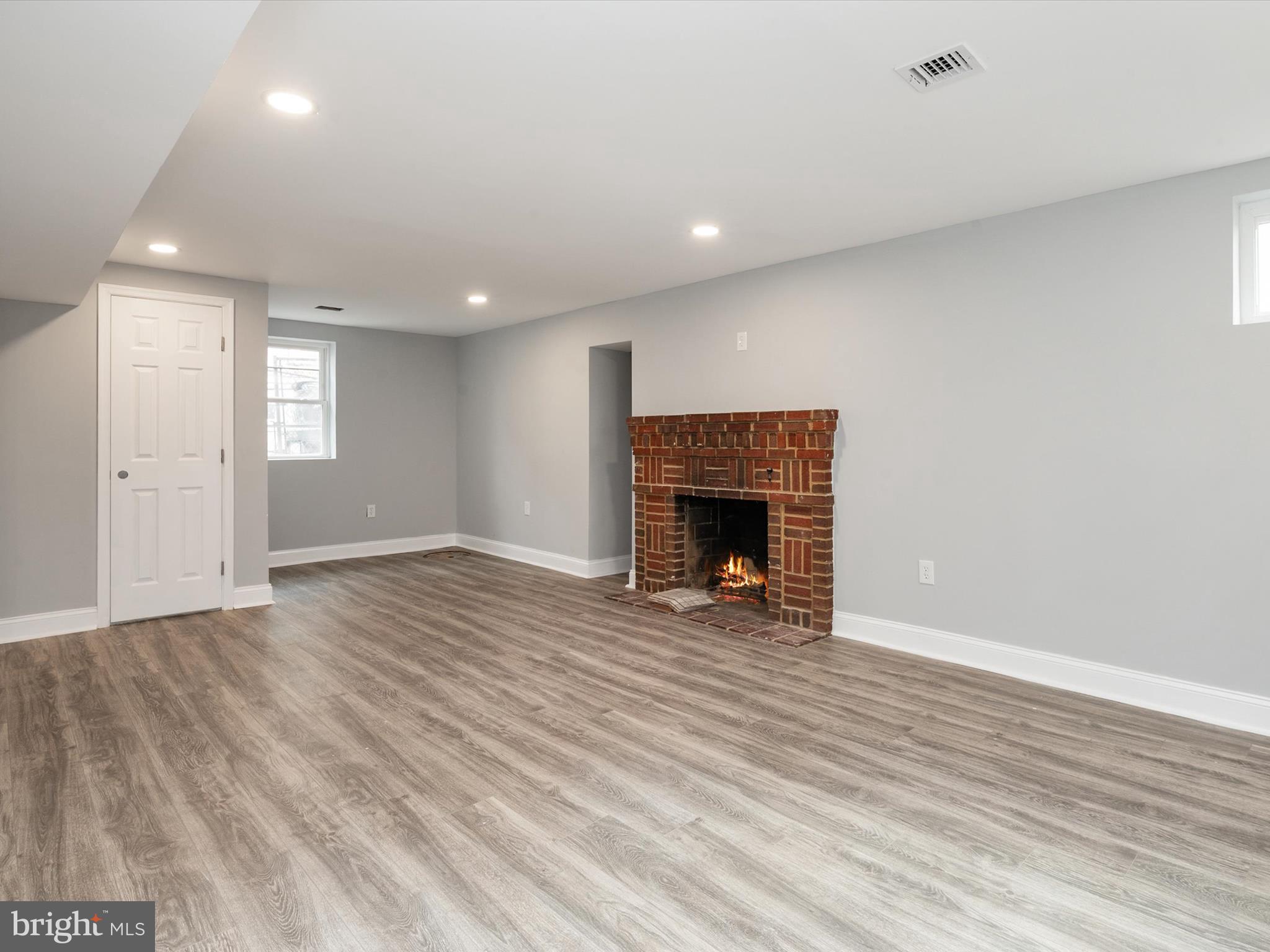 5002 Silver Hill Road Suitland, MD 20746 - Photo 25 of 39 an empty room with wooden floor and fireplace