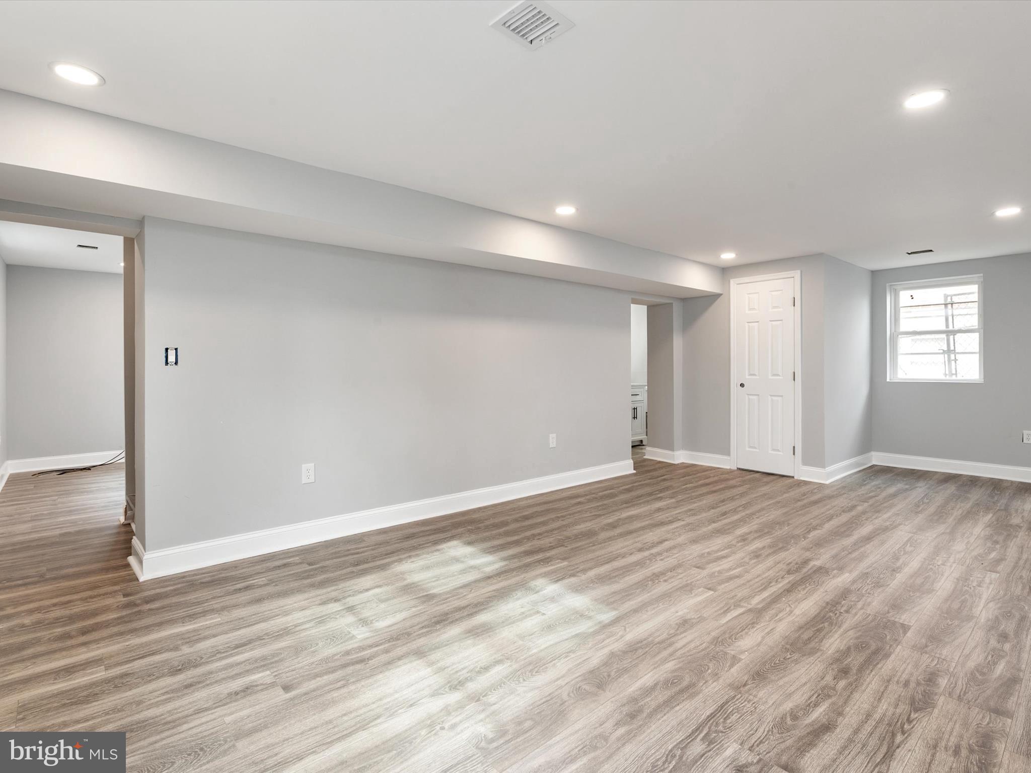 5002 Silver Hill Road Suitland, MD 20746 - Photo 26 of 39 an empty room with wooden floor and windows