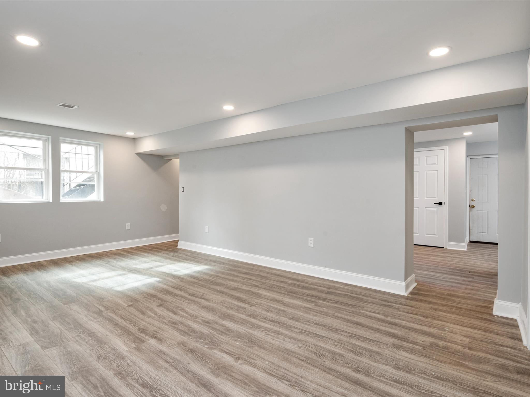 5002 Silver Hill Road Suitland, MD 20746 - Photo 27 of 39 an empty room with wooden floor and windows