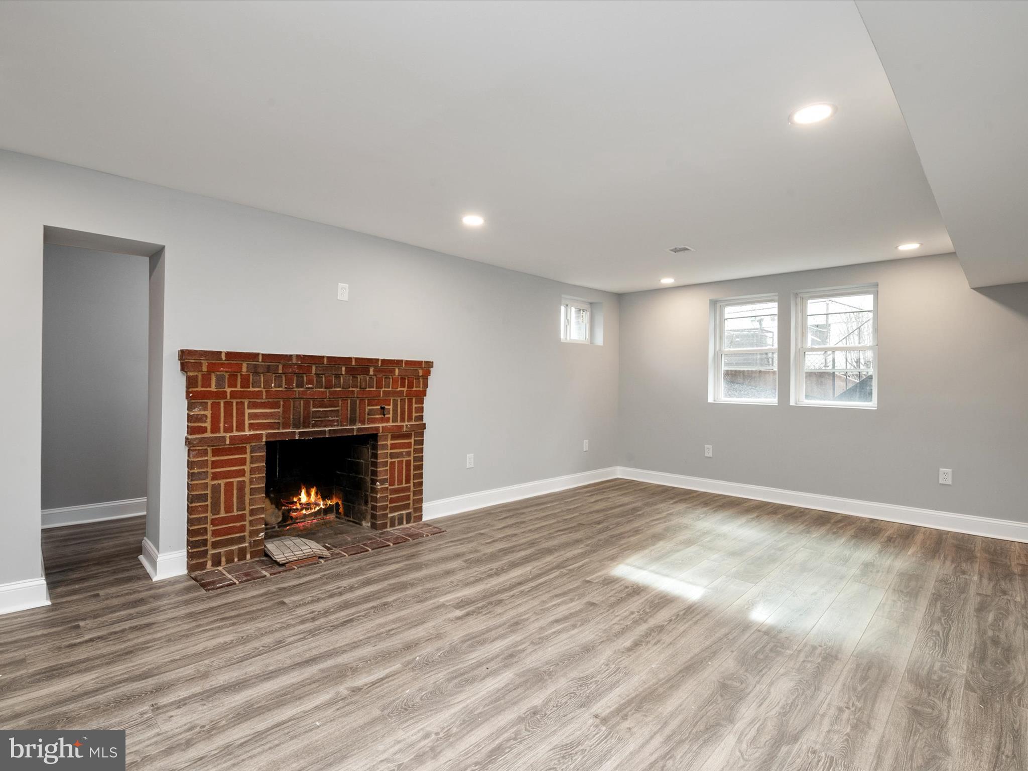 5002 Silver Hill Road Suitland, MD 20746 - Photo 28 of 39 a view of an empty room with wooden floor fireplace and a window