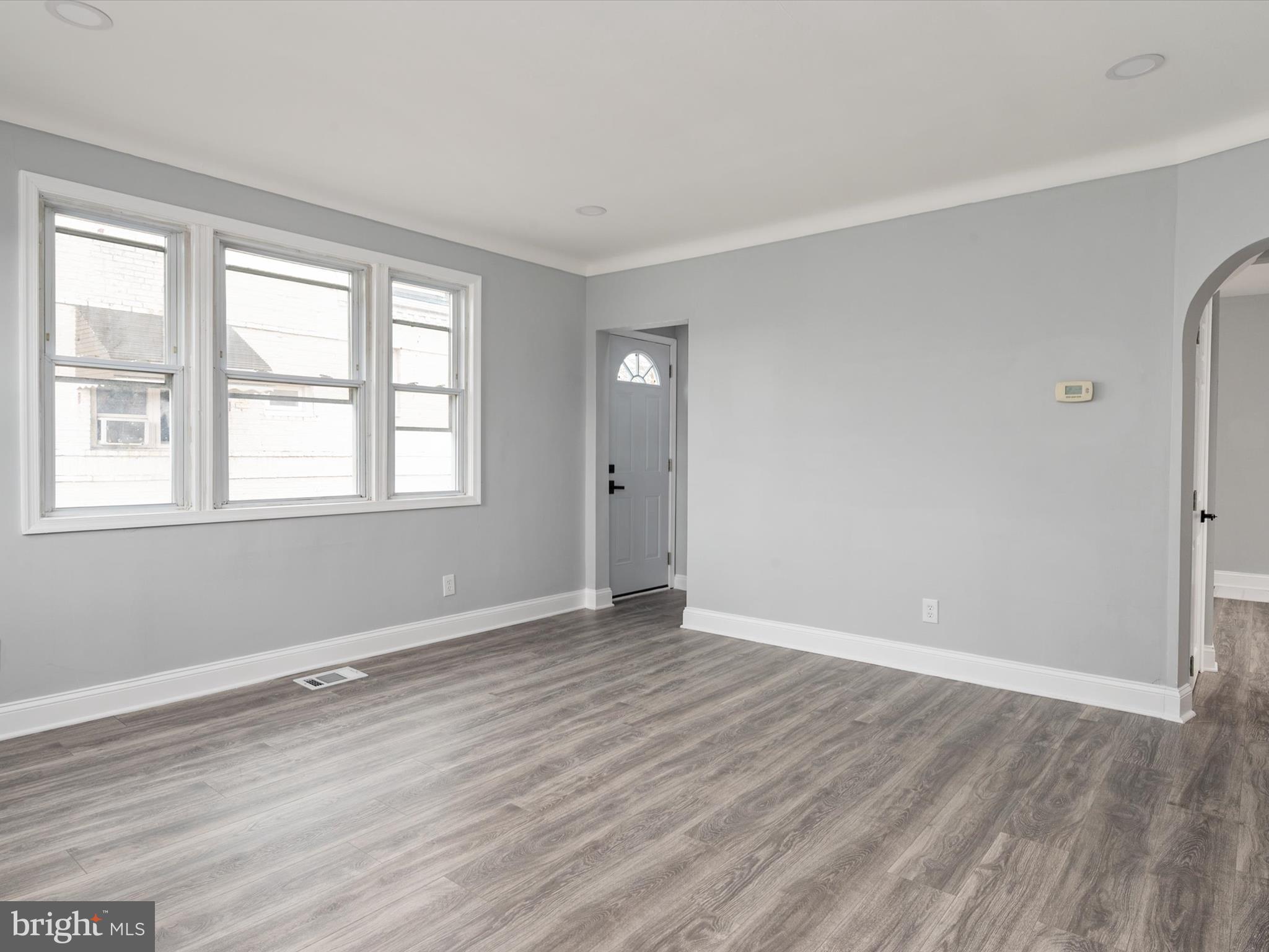 5002 Silver Hill Road Suitland, MD 20746 - Photo 6 of 39 a view of an empty room with wooden floor and a window