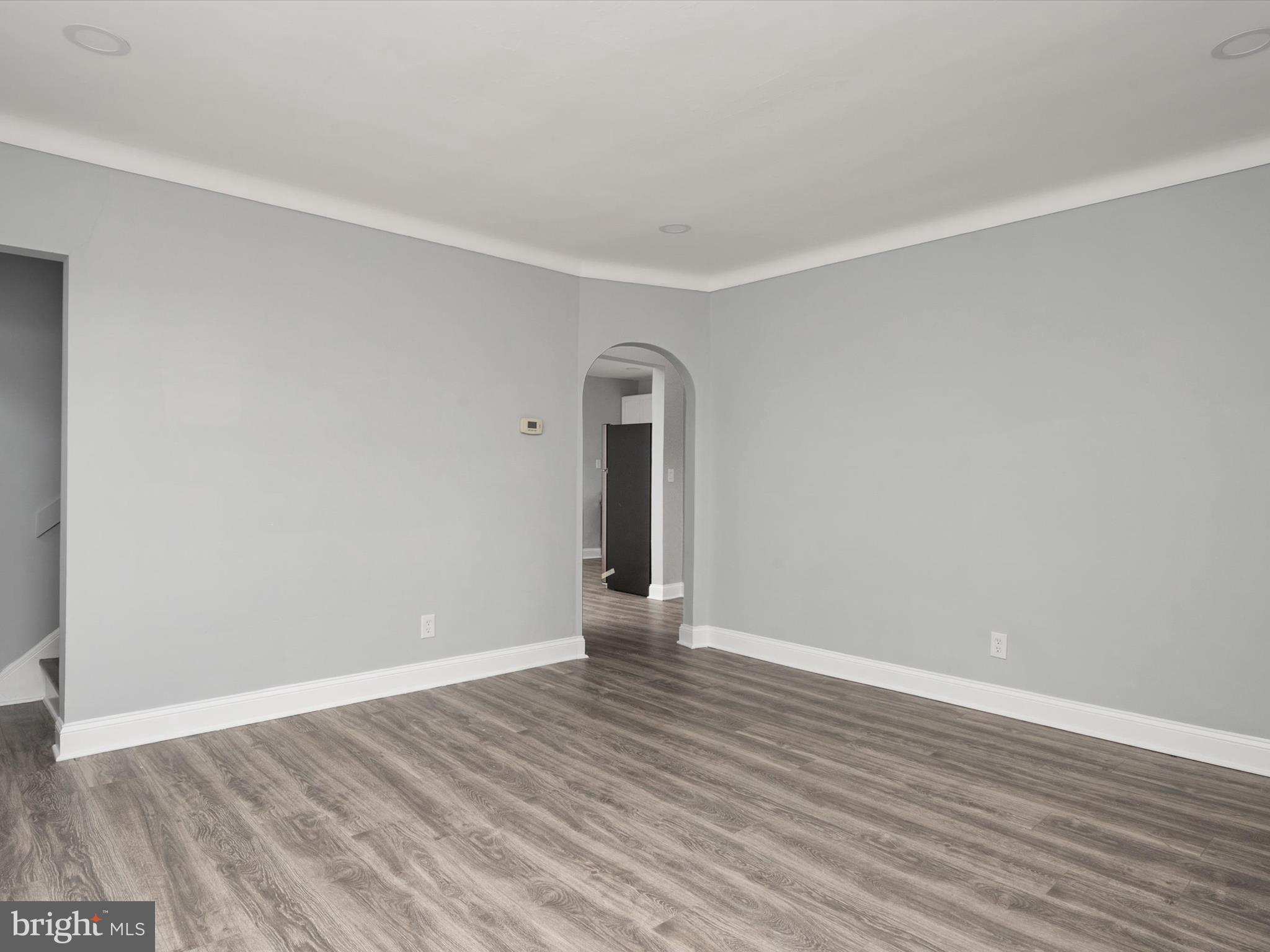5002 Silver Hill Road Suitland, MD 20746 - Photo 7 of 39 a view of an empty room with wooden floor and a window