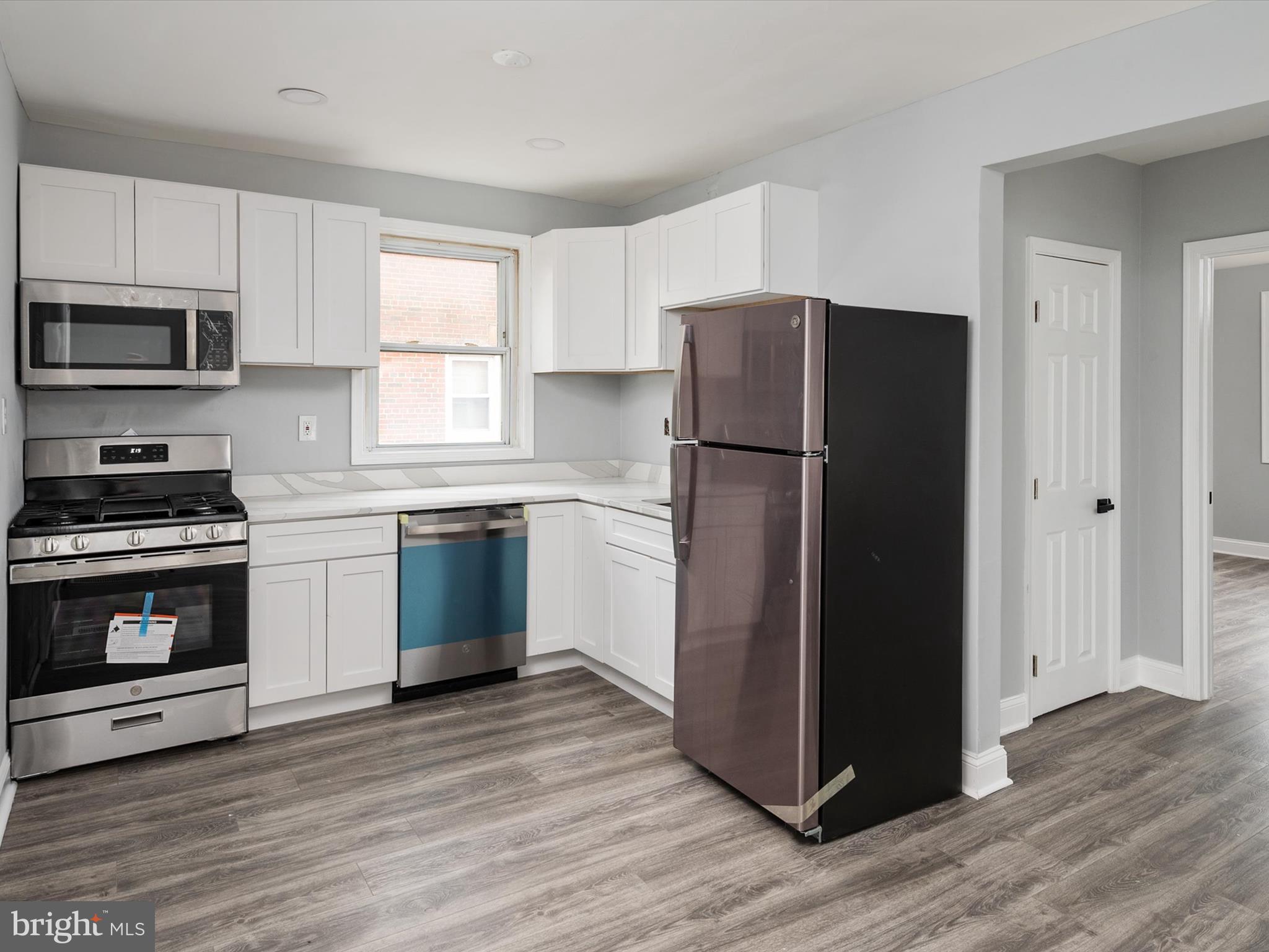 5002 Silver Hill Road Suitland, MD 20746 - Photo 10 of 39 a kitchen with a refrigerator cabinets and wooden floor