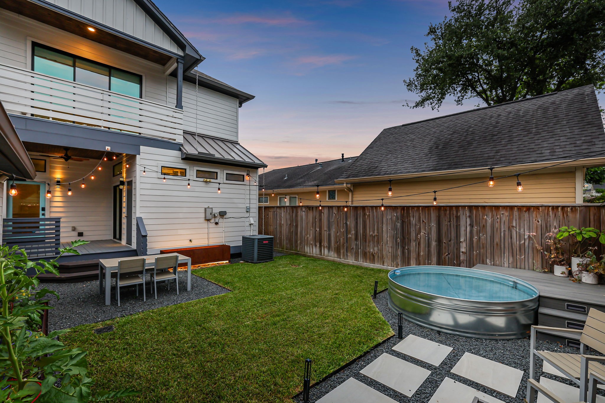 914 Robbie Street Houston, TX 77009 - Photo 7 of 50 a view of a backyard with table and chairs with wooden fence