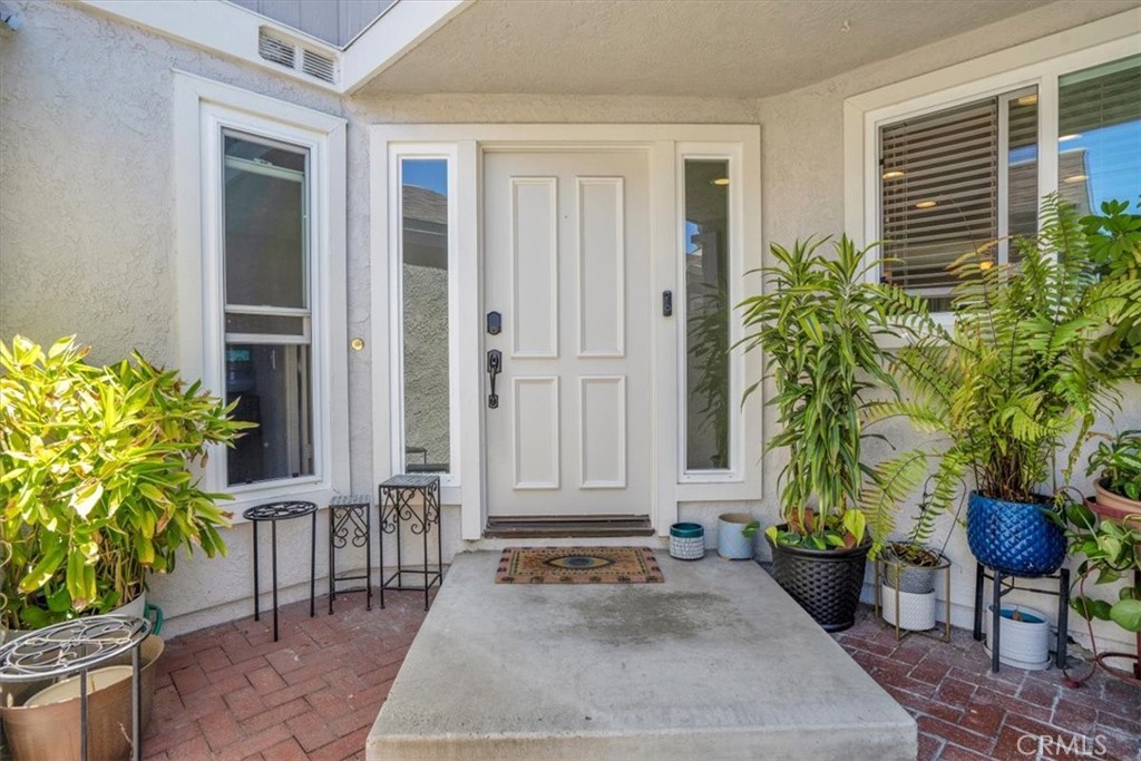 12 Sparrow Hill Lane Laguna Hills, CA 92653 - Photo 16 of 45 a house with potted plants in front of door