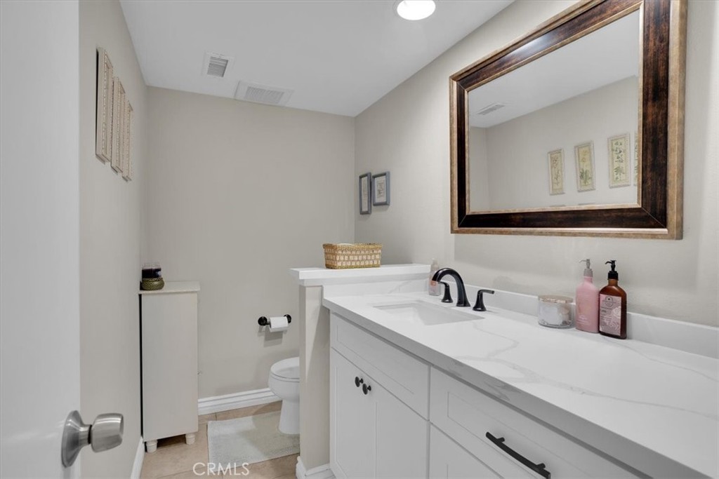 12 Sparrow Hill Lane Laguna Hills, CA 92653 - Photo 17 of 45 a bathroom with a sink a toilet and a mirror