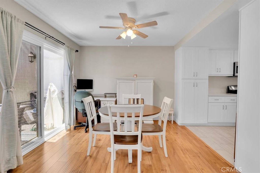 12 Sparrow Hill Lane Laguna Hills, CA 92653 - Photo 21 of 45 a view of a dining room with furniture a chandelier and wooden floor