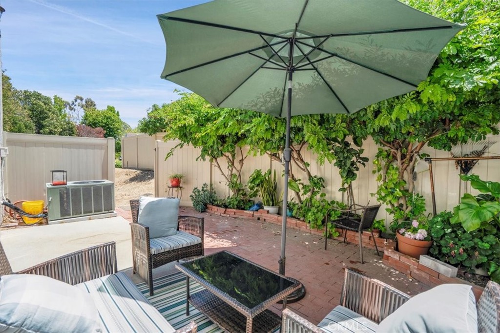 12 Sparrow Hill Lane Laguna Hills, CA 92653 - Photo 27 of 45 a view of a patio with couches under an umbrella