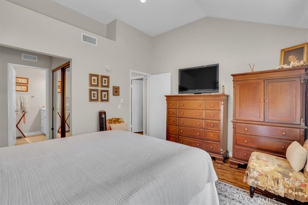 12 Sparrow Hill Lane Laguna Hills, CA 92653 - Photo 40 of 45 a bedroom with a bed and wooden floor