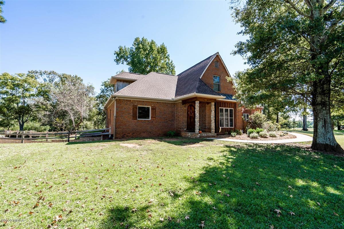 545 Gose Road Forsyth, GA 31029 - Photo 2 of 36 a front view of house with yard and trees in the background