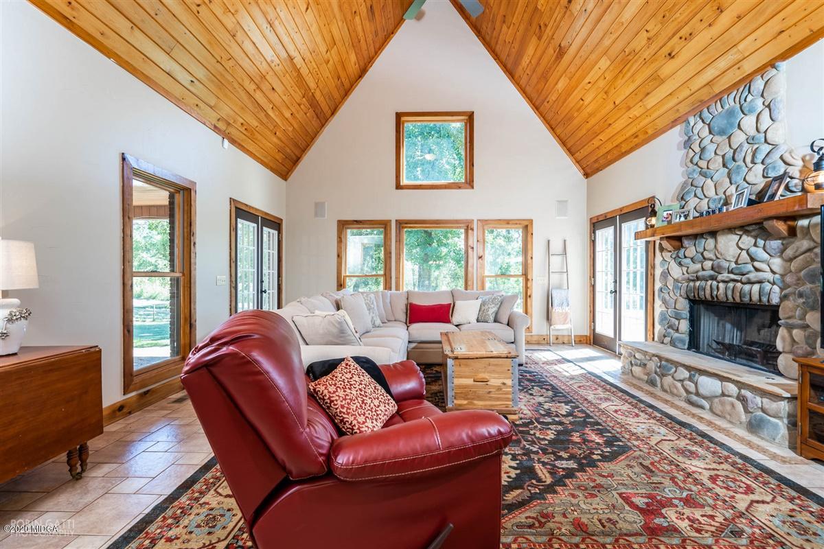 545 Gose Road Forsyth, GA 31029 - Photo 12 of 36 a living room with furniture a window and a fireplace
