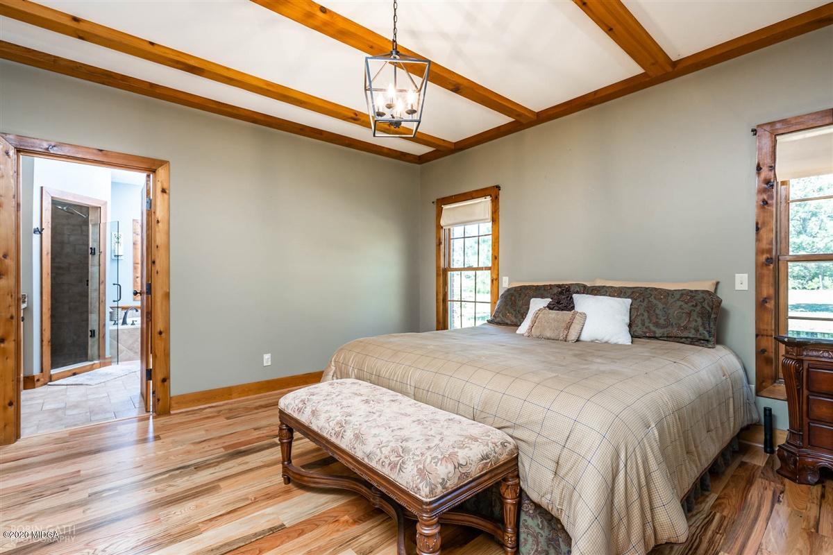 545 Gose Road Forsyth, GA 31029 - Photo 17 of 36 a bedroom with a bed and wooden floor