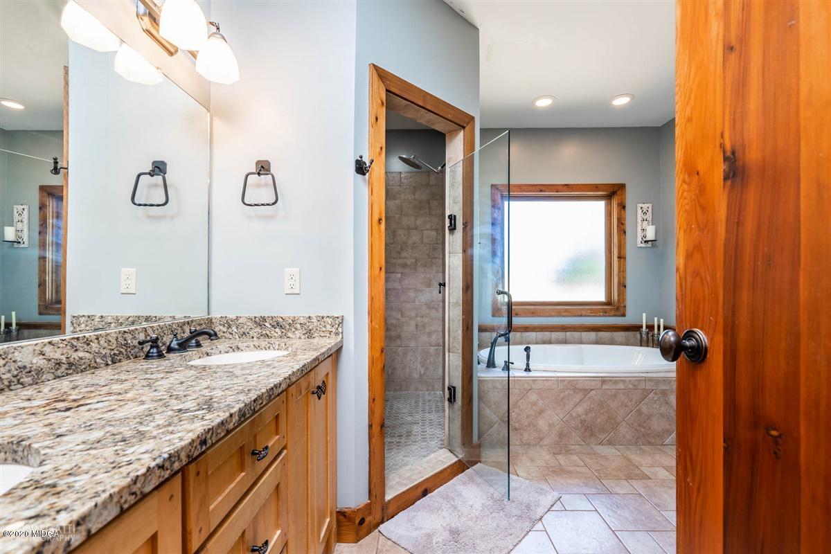 545 Gose Road Forsyth, GA 31029 - Photo 19 of 36 a bathroom with a granite countertop sink and a mirror