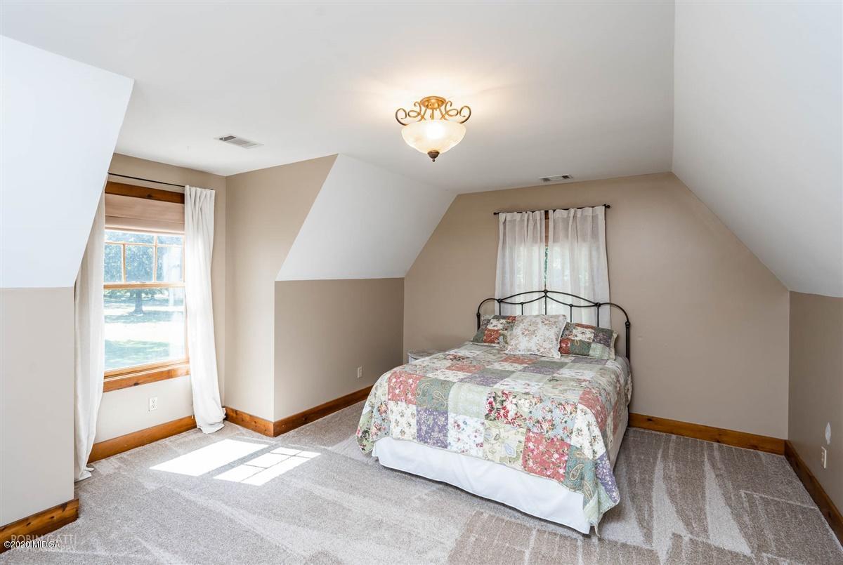 545 Gose Road Forsyth, GA 31029 - Photo 21 of 36 a bedroom with a bed and a window