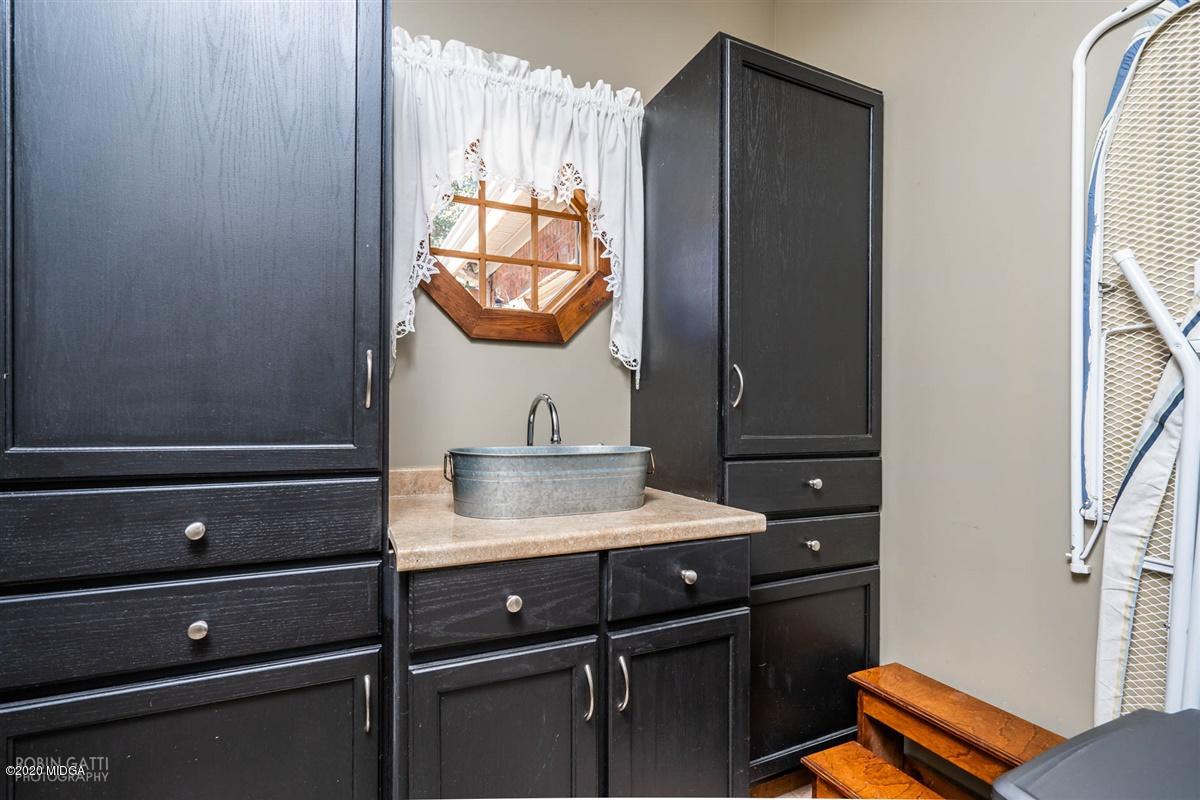 545 Gose Road Forsyth, GA 31029 - Photo 25 of 36 a bathroom with a sink vanity and mirror