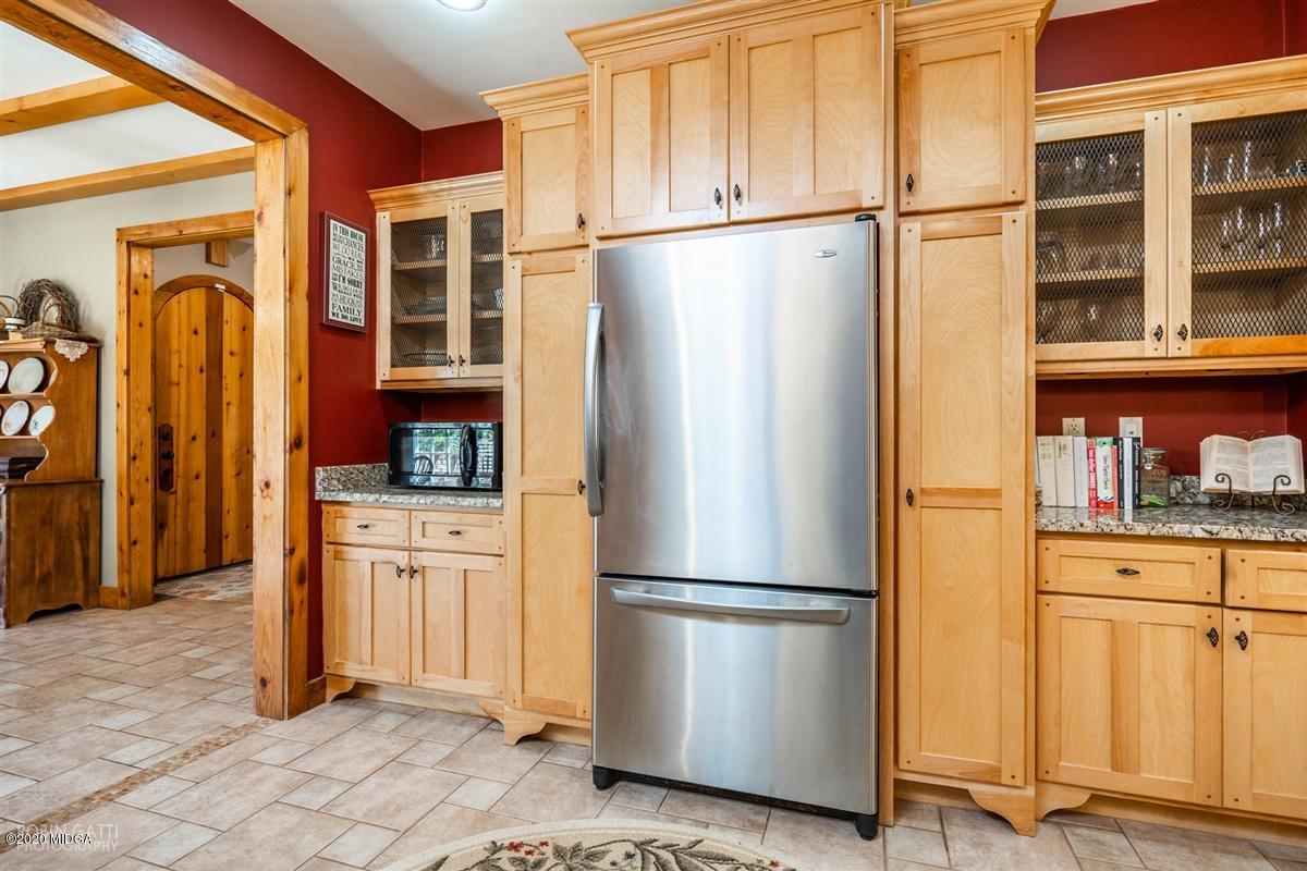 545 Gose Road Forsyth, GA 31029 - Photo 9 of 36 a kitchen with stainless steel appliances granite countertop a refrigerator and a stove top oven