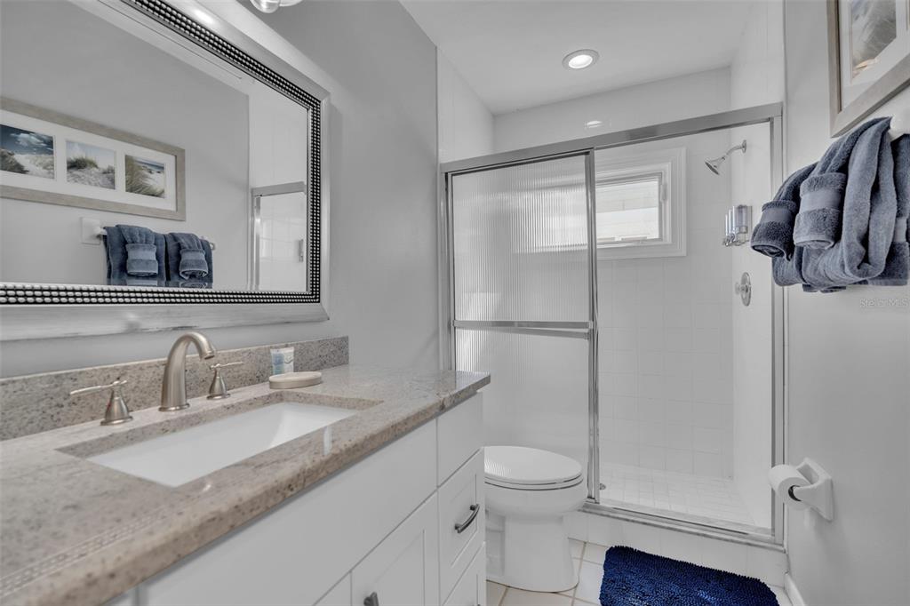 848 Evergreen Way Longboat Key, FL 34228 - Photo 21 of 66 a bathroom with a granite countertop sink mirror vanity and toilet