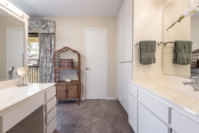 a bathroom with a double vanity sink toilet and mirror