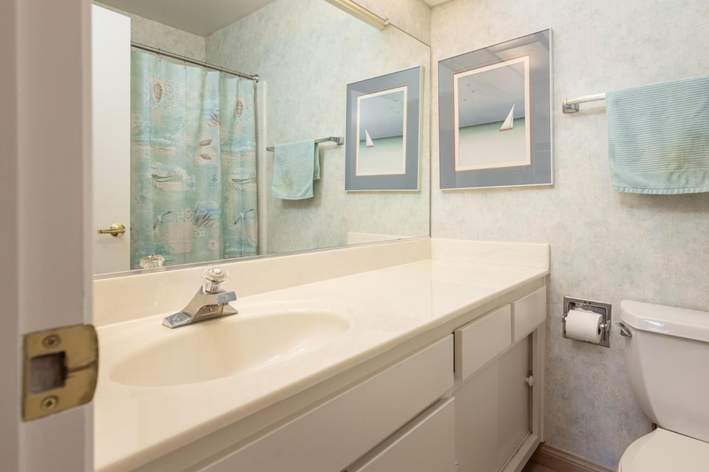1360 Josselyn Canyon Road, Unit 40 Monterey, CA 93940 - Photo 13 of 18 a bathroom with a sink and mirror with toilet