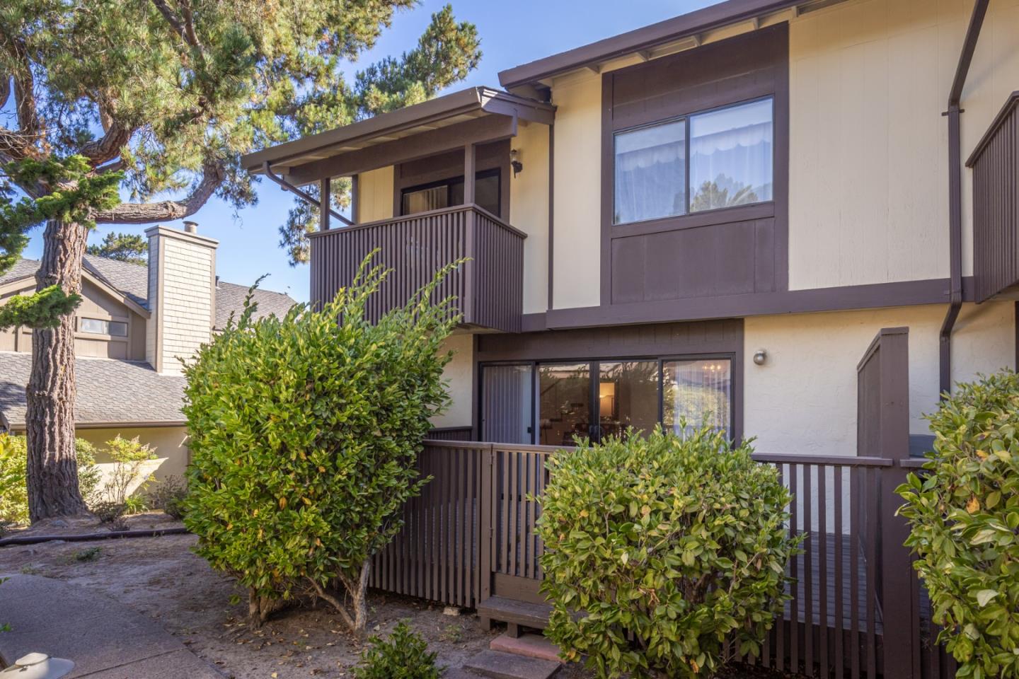 1360 Josselyn Canyon Road, Unit 40 Monterey, CA 93940 - Photo 4 of 18 a front view of a house with garden