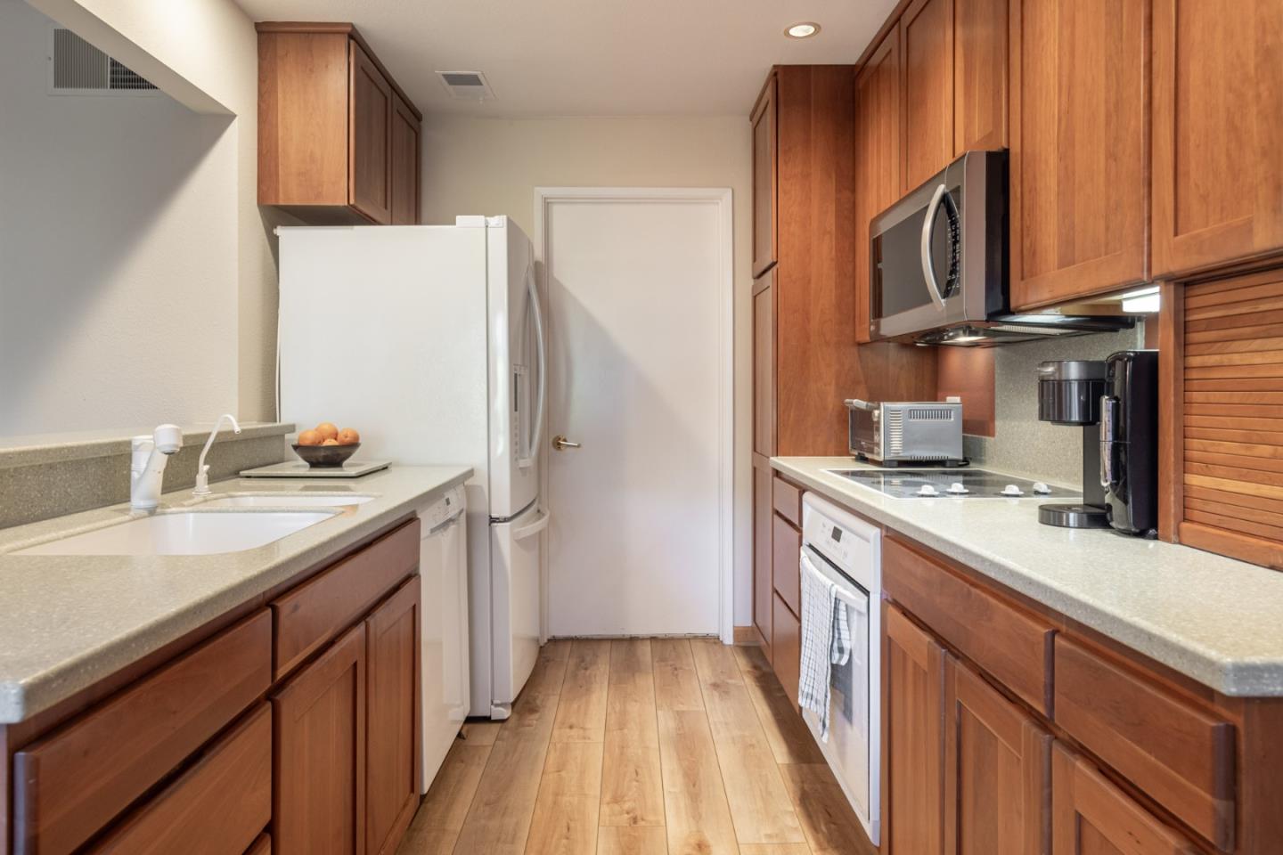 1360 Josselyn Canyon Road, Unit 40 Monterey, CA 93940 - Photo 7 of 18 a kitchen with stainless steel appliances granite countertop a refrigerator stove and sink