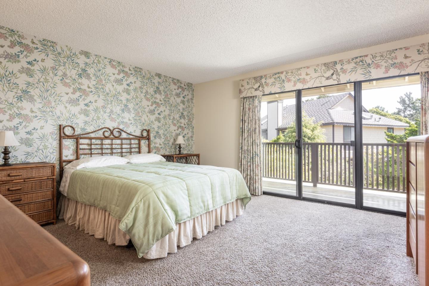 1360 Josselyn Canyon Road, Unit 40 Monterey, CA 93940 - Photo 9 of 18 a spacious bedroom with a bed and a large window