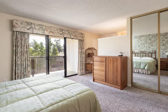 a spacious bedroom with a large bed and a large window